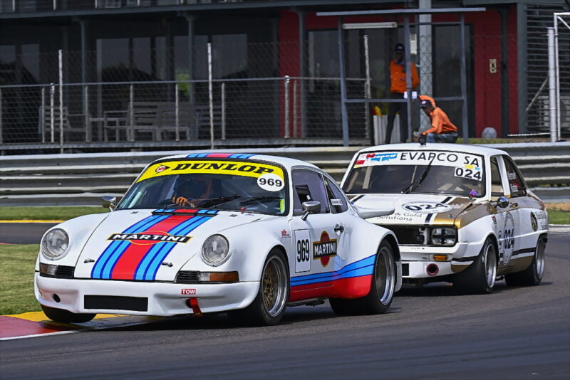 The first Evapco HRSA heat for cars in Classes A, B, C, D and E was won by Keegan Campos (Porsche 911 RSR), just beating the flame-spouting Black and Gold Solutions Mazda R100 Rotary of Werner Kotze. Photograph: Dave Ledbitter